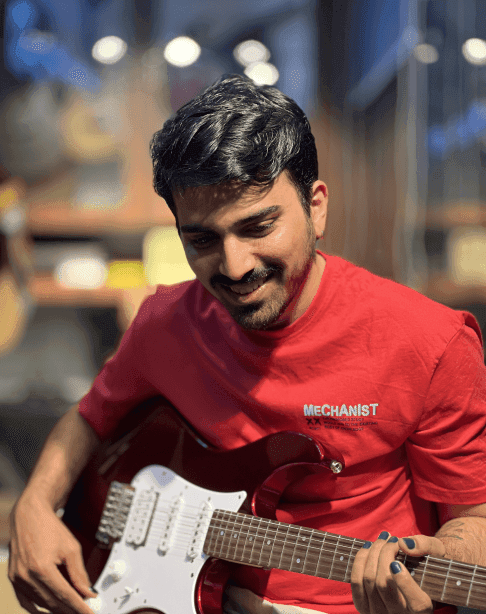 Mrithyunjay playing an electric guitar.